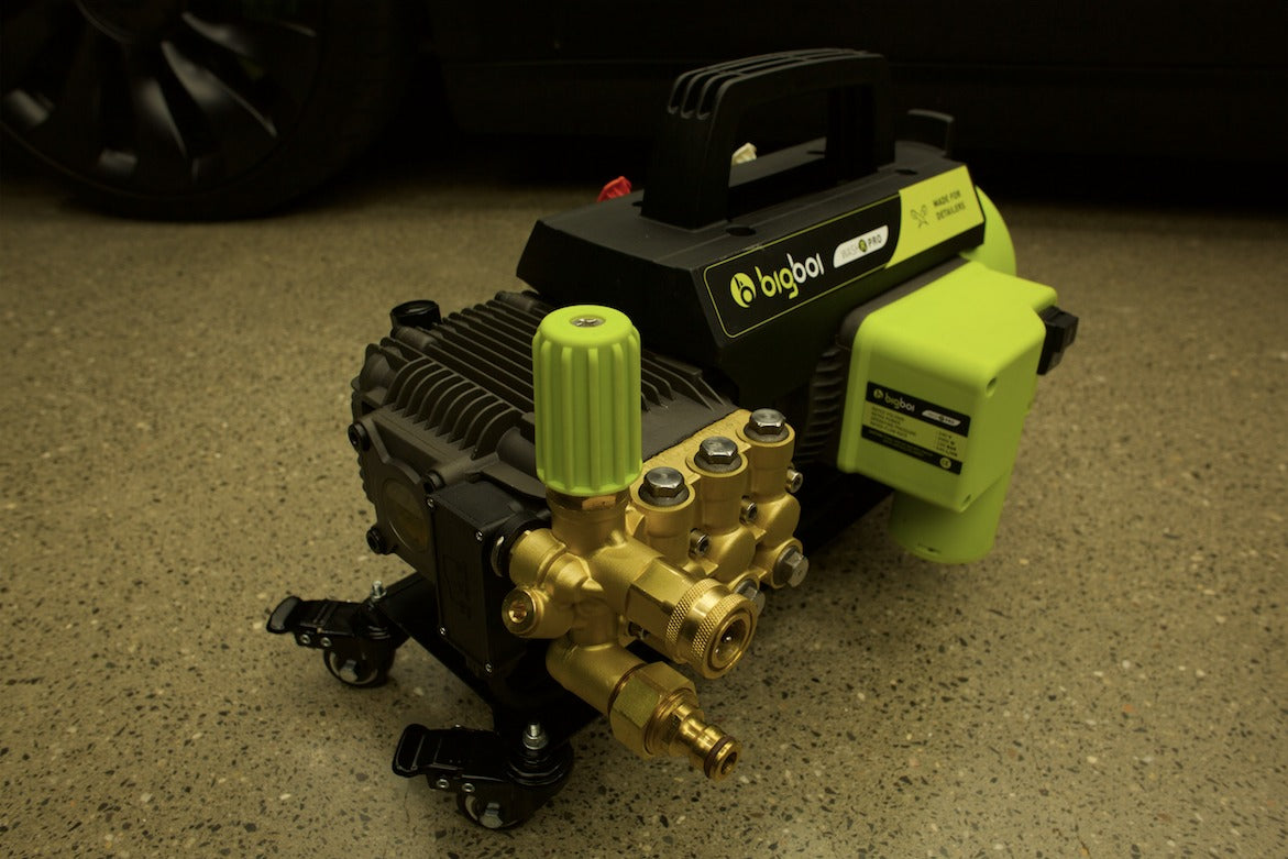 Pressure washer WashR PRO pump with visible branding on a concrete surface